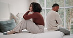 Unhappy, couple and angry with fighting on bed for toxic marriage conflict, argument or problem at home. Frustrated, people and stress with anxiety in miscommunication, disconnect or silent treatment