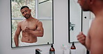 Man, mirror and muscle flex in bathroom for fitness results with towel, skincare and confidence for progress in home. Male person, reflection and strong body for exercise, dermatology and wellness