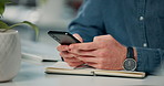 Businessman, hands and cellphone at desk with notebook for research and networking in office. Online, chat and notification for mobile app, journalist and website in workplace for telemarketing  