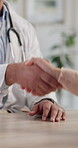 Handshake, doctor and patient in office for welcome, wellness and thank you with consultation success. Shaking hands, healthcare and trust for medical advice in hospital meeting with man and woman