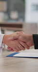 Doctor, patient and contract in office with handshake for medical agreement, healthcare and legal consent for procedure. Closeup, woman and man with shaking hands with document for risk disclosure.