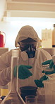 Drugs, lab and people in gas mask with chemicals for cooking methamphetamine, heroin and cocaine. Collaboration, crime and person in hazmat suit for illegal substances, narcotics and toxic products