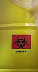 Toxic, biohazard and container in laboratory with danger sign for contaminated or chemical waste, science material and bin. Warning symbol, dangerous goods and barrel for environmental safety