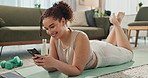 Woman, online and phone for yoga break in home, texting and app for conversation on floor. Female person, self care and rest from exercise or pilates challenge, social media and scroll on internet