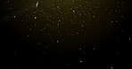 Dust, particles and black background with light rain, space or texture with gold sparkle. Firefly, powder or pattern of glitter dots, meteor shower or confetti glow for celebration on dark wallpaper