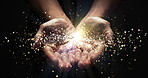 Hands, praying and lights shine for enlightenment, magic or spiritual realm on black background. Person or astrologer for hope, future or fortune telling with bokeh glow for palm reading in astrology