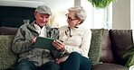 Senior, couple and happy with tablet in home, laughing and social media in retirement or people together on sofa. Relax, bonding and streaming funny videos online, living room and connection in house