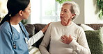 House, nurse and old woman on sofa, consultation and conversation for heart rate, checkup and cardiology. Apartment, caregiver or senior patient on couch, medical and help with professional or advice