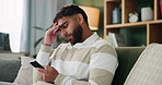 Man, phone and sad on sofa with anxiety from message, conflict or bad news in home. Indian guy, stress or argument on cell with depression, regret and toxic relationship or negative feedback on couch