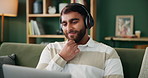 Man, smile and thinking with headphones on laptop for streaming music video, podcast or movie on social media. Person, ideas  and earphones for typing film choice, entertainment and lounge at house
