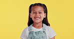 Young girl, face and smile in dungaree on studio background for playful, innocent and fashion. Child, portrait and happy in casual, comfortable and denim clothes with excitement for back to school