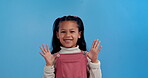 Young,  girl and happy in dungaree in studio on blue background for playful, innocent and fashion. Child, portrait and smile in casual, comfortable and cool clothes with excitement for back to school