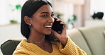 Happy girl, relax and laughing on sofa with phone call in discussion, gossip or humor at home. Young indian or female person with smile on mobile smartphone for friendly conversation or chat at house