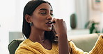 Calm woman, relax and eating chocolate on sofa for sweet snack, dessert or candy at home. Face of happy and young female person with smile, bite and enjoying cocoa delight in living room at house