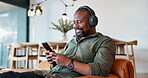 Black man, relax and headphones with music on phone for streaming video, podcast and networking on social media. African, male person and mobile for listening, playlist audio and dancing at home