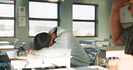 School, tired and student sleeping in classroom bored from lesson, learning and studying at desk. Throw paper, college and boy with fatigue, burnout or exhausted nap for test, exam or education