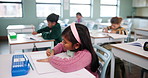 Student, girl and classroom for education at school with learning, knowledge and drawing for creative development. Child, paper and erase mistake, writing and lesson test, activity and future growth