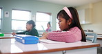 Girl, student and classroom for education at school with learning, knowledge and drawing for creative development. Child, paper and sketch, writing and lesson test, activity and future growth