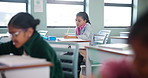 Girl, student and writing in classroom for learning, education and problem solving by desk with knowledge. Child, study and exam in elementary school with pencil for development, growth and project