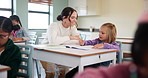 Teacher, woman and help kid for education, studying or writing knowledge in book at class. Child, happy educator and student learning in lesson for development, teaching and support in kindergarten