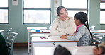 Teacher, happy woman and help kid for education, study or writing knowledge in book at class. Child, educator and student learning in lesson for development, teaching and support in elementary school