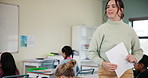 Student, teacher and girl in school, marks and asking of assignment for homework and woman. Classroom, happy and education for child, desk and chat for knowledge, learning and helping with project