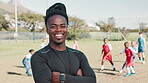 Football, face and man coach in stadium with arms crossed, happiness and pride for team building in sports. Soccer field, male trainer and confidence for player development, leadership and game plan