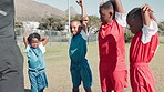 Football field, exercise and team of kids with stretching for workout, practice and warm up in sports. Children, trainer and boys with flexibility in circle for coaching, training and development