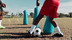 Child, ball and practice for soccer with coach on field with kick, inflatable or training with fitness. Football club, boy and back for match workout, drill and player on grass for sport or exercise