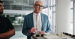 Man, presentation with model and architect for building, plan or idea in office. Male engineer, project management and talk in workplace for construction, corporate real estate opportunity or vision