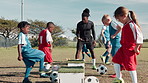 Soccer ball, sports and children with coach for training, workout and exercise for practice, learning and fitness. Youth club, field and kids with equipment for playing games, match and competition