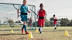 Boy, children and workout on grass for soccer with resistance band, harness or running for speed development. Coach, man and kids in football with timelapse, cone and diversity for fitness on field