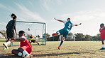 Football, coach and children in stadium for shooting, practice and exercise for sport competition. Soccer field, goalkeeper and trainer with players for training, kick and celebration for scoring