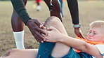 Soccer, player and knee pain for injury, accident and muscle tension during kick in sports competition. Football field, hands and coach with boy for helping, support and patellar tendinitis for kid