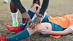 People, hands and injury in sports with help for crisis, water for knee graze or burn. Coach, child football player or support in stadium for accident in game, training with medical emergency or pain