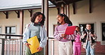 Children, friends and talking at school together, books and walking to classroom for education. Kids, girls and conversation for learning or knowledge, students and speaking on project in outdoor