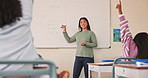 Teacher, woman and children with raised hand, board and question for learning, math and quiz at academy. Person, education and school kids with problem solving, solution and lesson for development