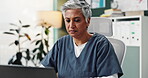 Mature, woman and nurse with laptop in office for medical research, reading information and schedule consultation. Person, digital and typing for Telehealth, history record and test results at clinic