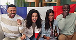 People, friends and celebration on sofa watching tv for soccer, world cup or sports event in living room. France flag, diversity and group with alcohol, happiness or goal from football team in home