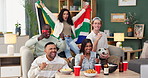 Group, friends and celebration on sofa watching tv for soccer, world cup or event in living room. South African flag, diversity and people with alcohol, happiness or goal from football team in home
