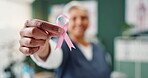 Ribbon, hand and breast cancer awareness for healthcare, support and empathy with nurse in office. Community, medical care and examination for prevention, treatment and female person advocate 