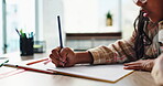 Alphabet, child and hand on desk, writing and closeup of education, notebook and student in middle school. Classroom, studying and practice for exam, growth and development of kid, letters and table