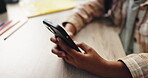 Cellphone, hands and desk for kid, education and closeup of research and online for project in middle school. Classroom, typing and youth with mobile for answer of question, growth and development