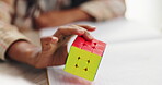 Color, cube and puzzle on hands, challenge and closeup of student in classroom with notebook and desk. Middle school, growth and development of child with game of pattern, solving and goal for kid