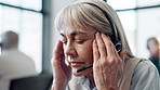 Help desk, call center and woman with headache, stress and pain with crisis, telemarketing and overworked. Mature person, employee and agent with headphones, mistake and migraine with burnout and crm