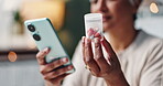 Hands, cellphone and research of medicine, online and health of senior person, closeup and bokeh in house. Home, digital and information on label of bottle, medical and pills of pharmacy with woman