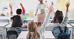 Back, children and hands for answer in classroom with question, knowledge and learning in education. Students, diversity group and curious at school with study, solution and feedback for exam or test