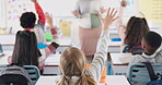 Back, children and raised hand for answer in classroom with question, knowledge and learning in education. Students, diversity group and curious at school with study, solution and feedback for exam