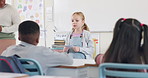 School, talking and child with presentation in classroom for lesson, learning and oral assessment. Education, students and girl with notes for public speaking, speech development or show and tell