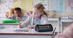 Girl, child and writing test in classroom, problem solving or exam for progress in education at academy. Pupil, school kids and math notes in book for learning, scholarship and thinking in Berlin